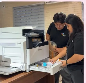 People servicing a printer